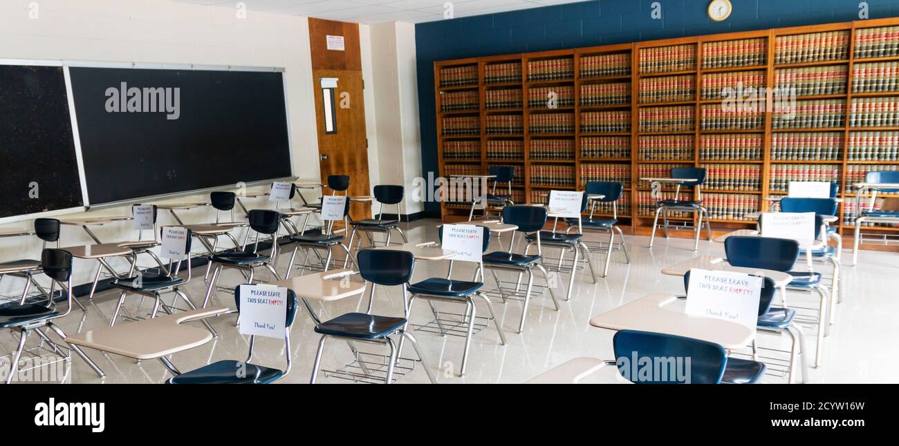 A high school classroom with papers on chairs that can not be sat in to help with social distancing and reopening the schools. Stock Photo