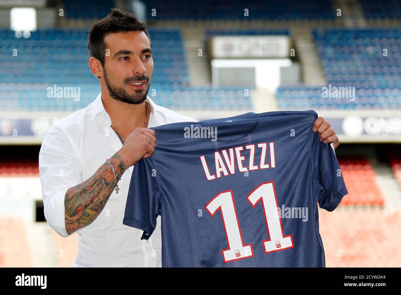 Ezequiel Lavezzi, newly-signed player for French soccer club Paris St  Germain, holds his new jersey after a news conference at the Parc des  Princes stadium in Paris July 2, 2012. REUTERS/Mal Langsdon (