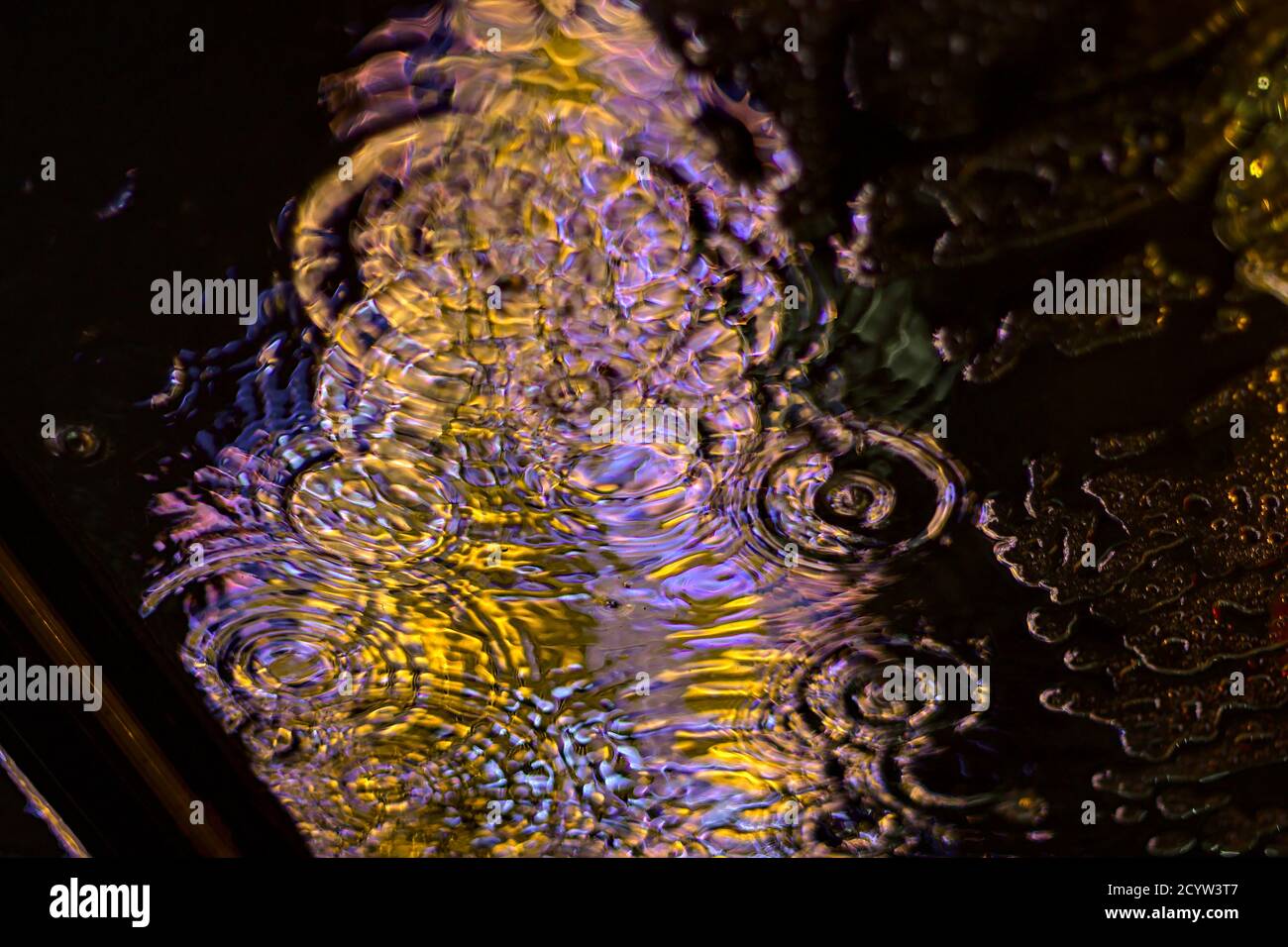 Ripples of water on plastic roof viewed from underneath Stock Photo