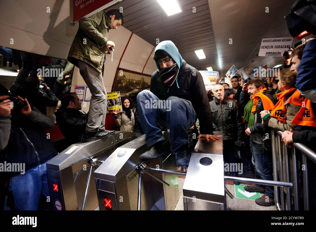 A Demonstrator Jumps Over A Turnstile During A Protest Against Private Security Guards At Taksim Metro