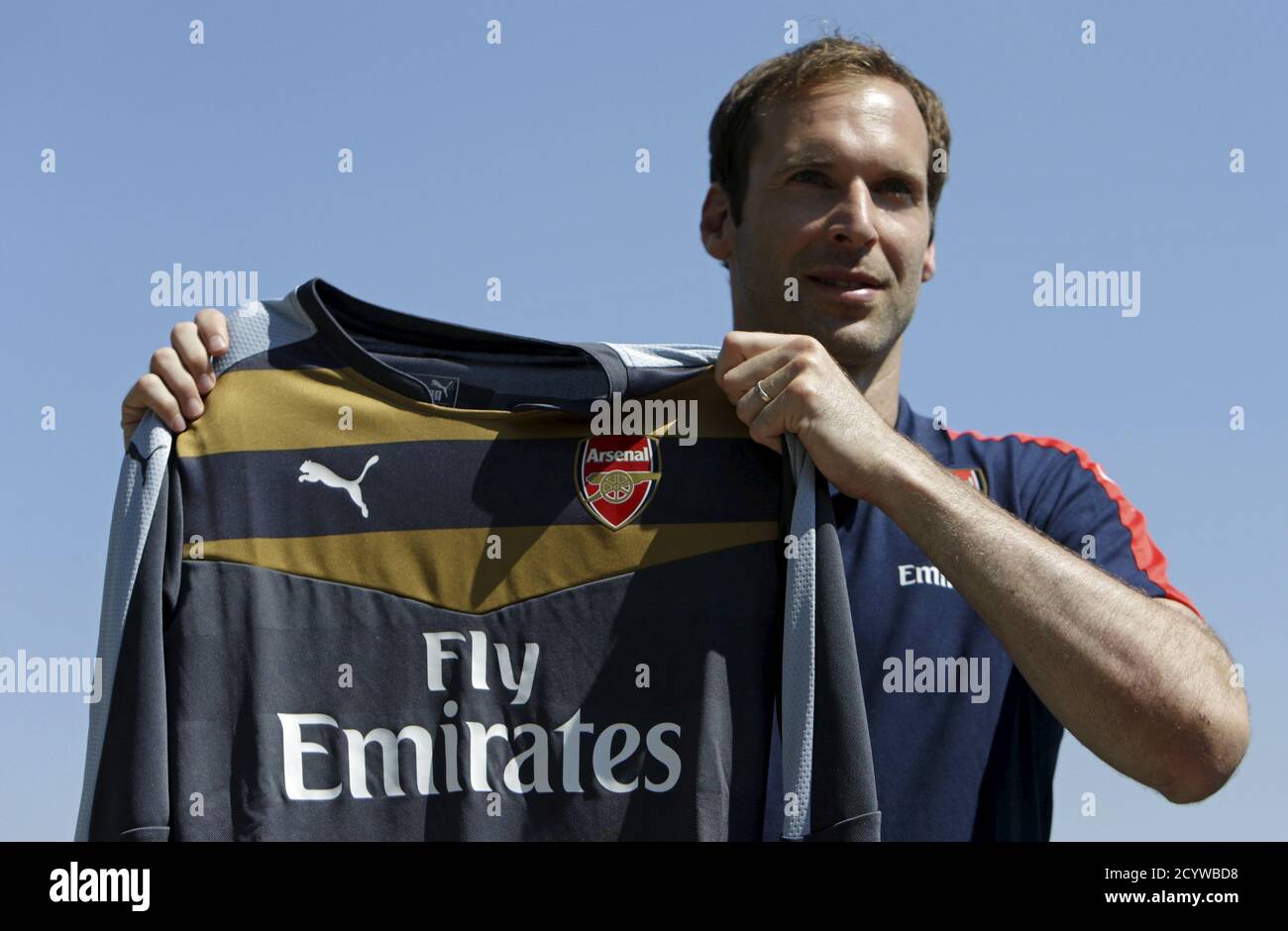 Czech soccer player Petr Cech shows his Arsenal jersey during his  presentation in Prague July 1, 2015. Petr Cech thanked Roman Abramovich  after the Chelsea owner allowed the club's long-serving goalkeeper to