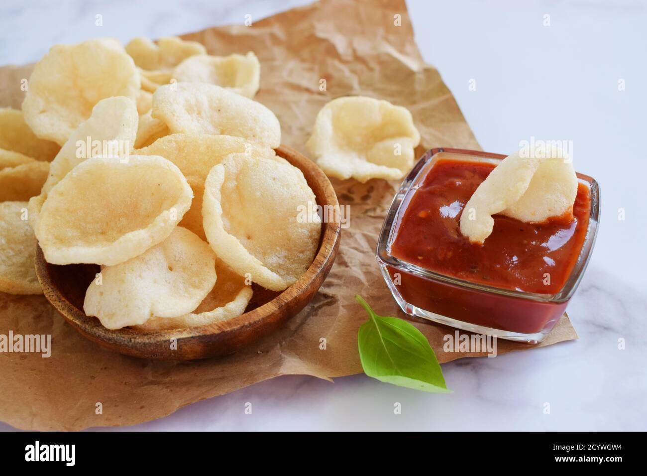 Prawn Crackers or Shrimp Chips with ketchup served on parchment paper