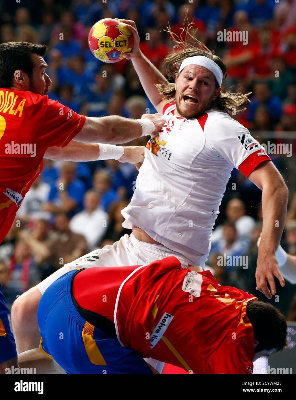 Denmark's Mikkel Hansen (R) is challenged by Spain's Gedeon Guardiola (L)  during their Men's Handball World Championship final match at the Palau  Sant Jordi arena in Barcelona January 27, 2013. REUTERS/Gustau Nacarino (