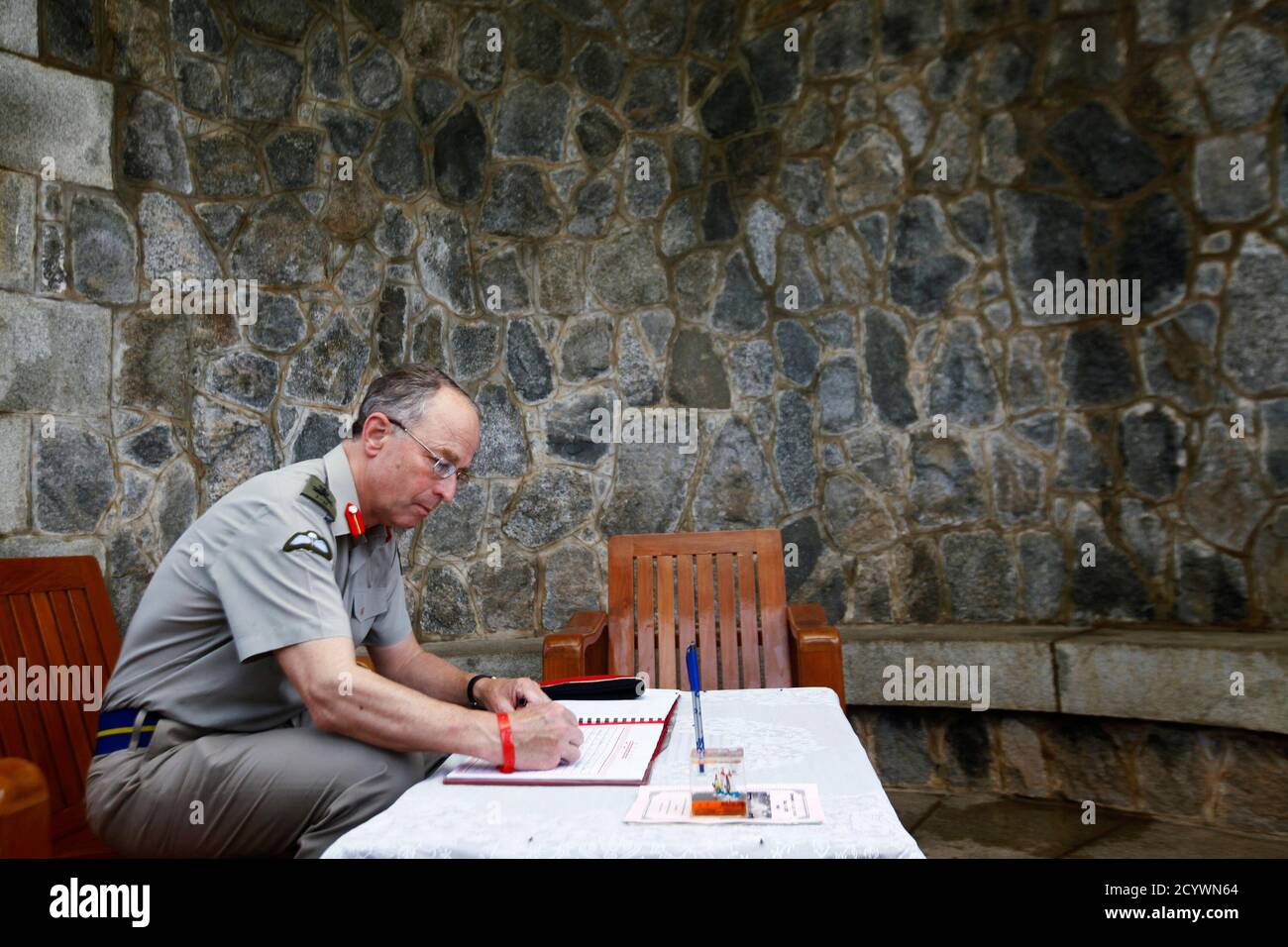 Britain's Chief of Defence Staff, General David Richards, signs the guest book during a visit to Taukkyan war cemetery, on the outskirts of Yangon, June 4, 2013. The cemetery is a memorial to Commonwealth soldiers who died in Burma, presently known as Myanmar, during World War Two. REUTERS/Minzayar (MYANMAR - Tags: MILITARY POLITICS CONFLICT) Stock Photo