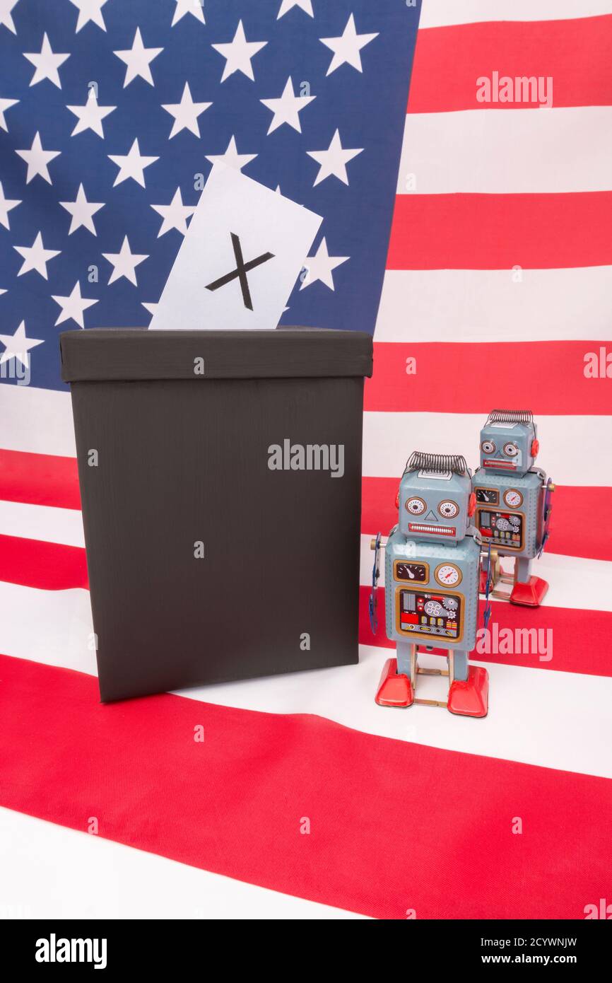 Wind-up clockwork toy robot on American flag / Stars & Stripes. For Russian Vulkan bots meddling in US American election, Russian trolls & robot AI. Stock Photo