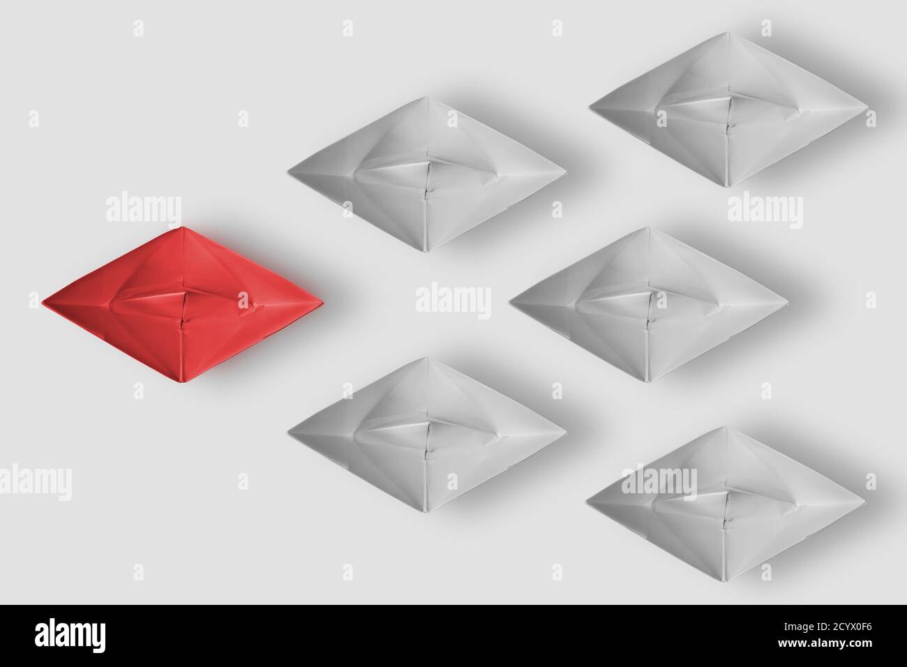 Leadership concept in business. Red leader paper ship lead group of ...