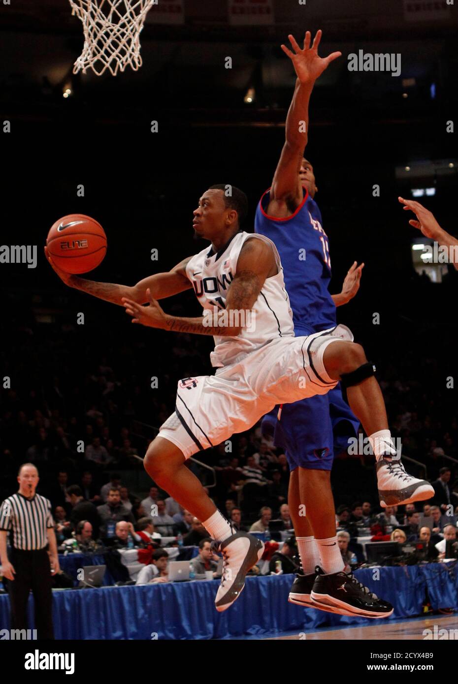 Uconn's Ryan Boatright (L) scores past De Paul's Cleveland ...
