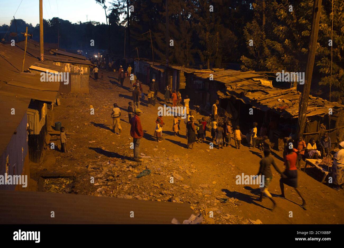 People Walk Back Home During Early Evening At The Kangemi Slum In Kenya S Capital Nairobi February 28 2013 Reuters Siegfried Modola Kenya Tags Society Stock Photo Alamy