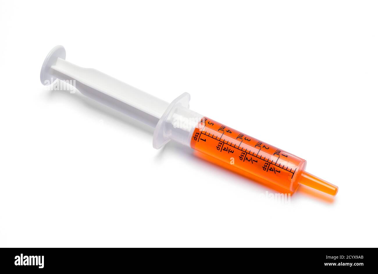 Oral Syringe With Orange Cough Medicine Dose. Stock Photo