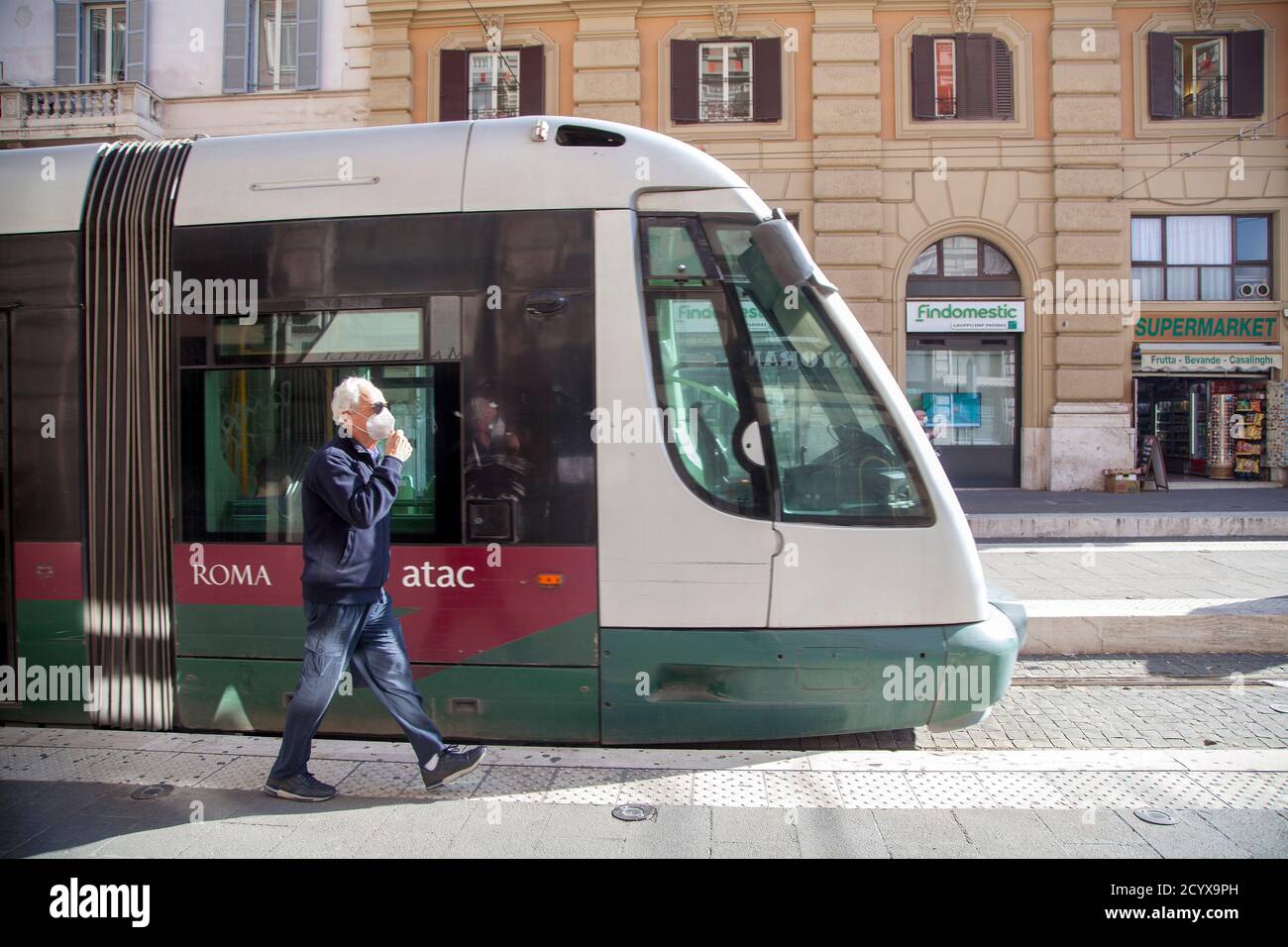 ROME, ITALY - OCTOBER 01 2020: Pedestrians, wearing protective face masks, disembark from a tram in Rome, Italy. Stock Photo