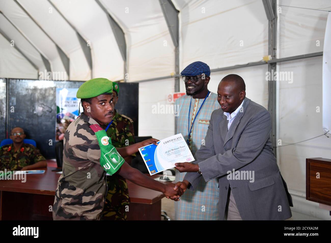 Mathias Ngarambe (right), Acting AMISOM's Head of Mission Support hands over a certificate to a medical officer at the end of a medical workshop jointly organized by the UNSOS and AMISOM in Mogadishu on 12 September 2018. Stock Photo