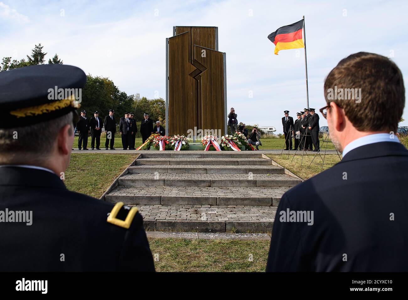 Geisa, Germany. 02nd Oct, 2020. Karl-Theodor zu Guttenberg (r), former Minister of Defense, and Joseph A. Papenfus, Brigadier General USAREUR, stand in front of a German flag one day before the Day of German Unity while laying a wreath at the Monument of German Division at the former U.S. camp 'Point Alpha'. Credit: Swen Pförtner/dpa-Zentralbild/dpa/Alamy Live News Stock Photo