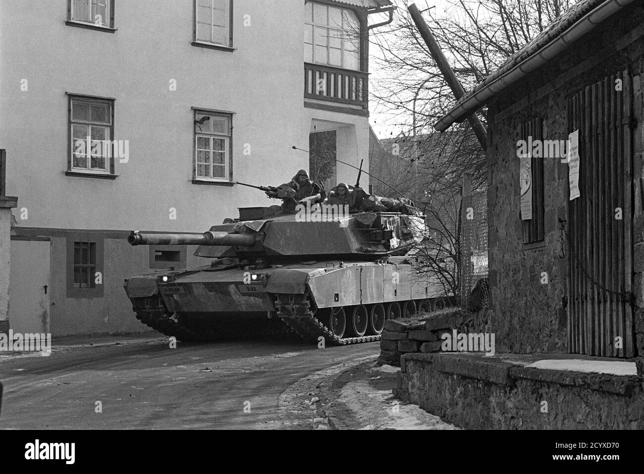 NATO exercises in Germany, M1 Abrams US Army tank in a village (January 1985) Stock Photo