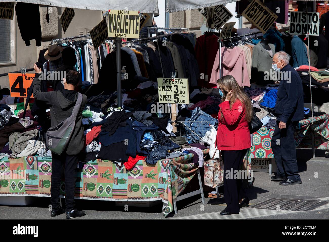 ROME, ITALY - OCTOBER 01 2020: Pedestrians browses for clothes on sale at a market stall in Rome, Italy. Stock Photo
