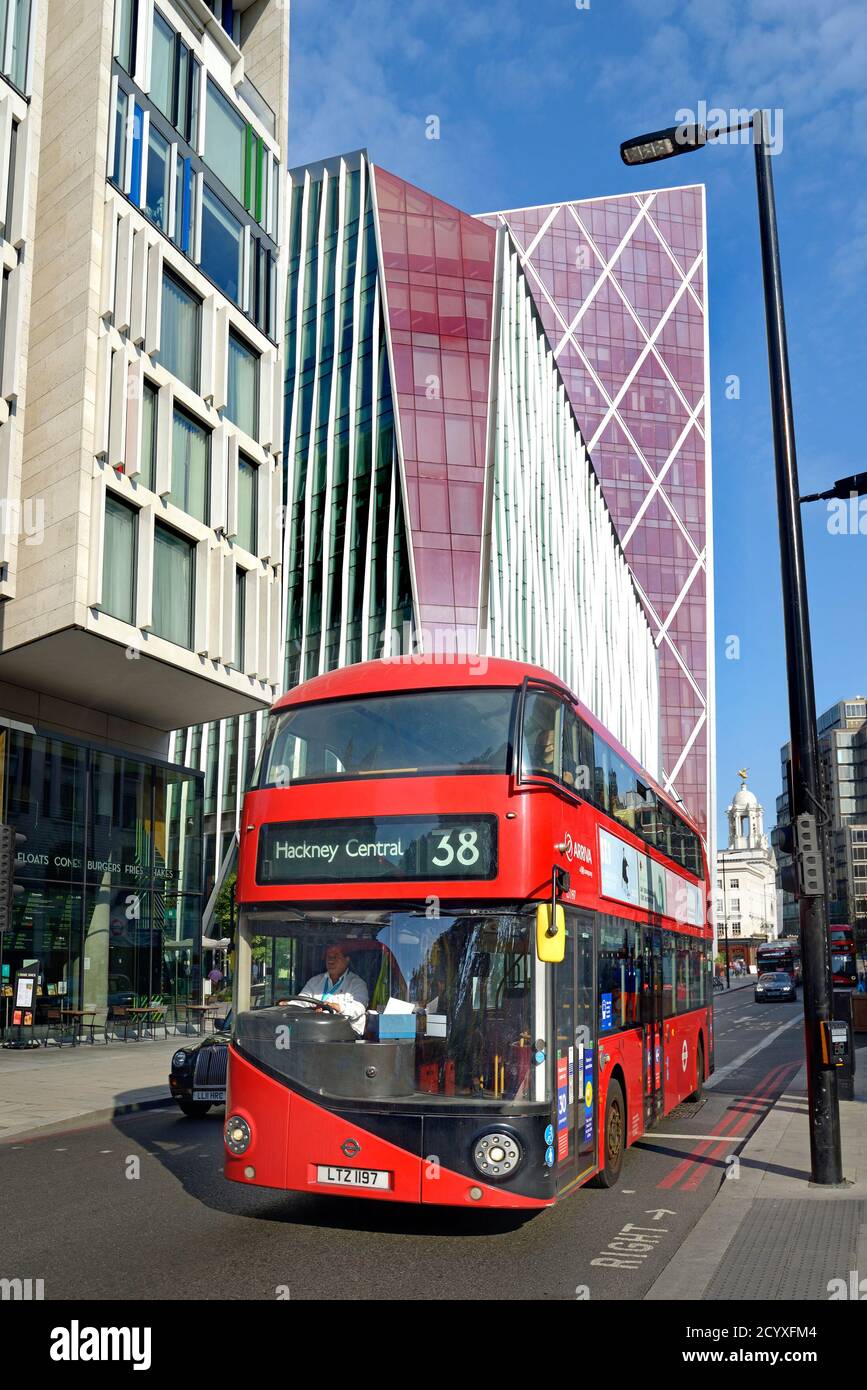 London, England, UK. Double decker red bus in Victoria passing the Nova Building (red) Stock Photo