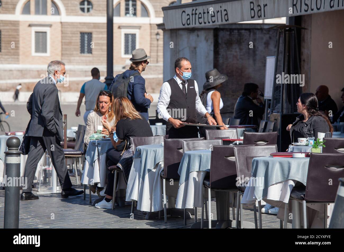 ROME, ITALY - OCTOBER 01 2020: Customers sit at a restaurant in Rome. Italy's economy is forecast to shrink 9% this year. Stock Photo