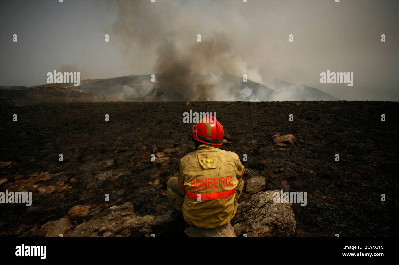 A Firefighter Rests Next To A Fire Burning At Arada Mountains Near Sao Pedro Do Sul August 9 10 More Than 700 Firefighters And Soldiers Are Trying To Extinguish Dozens Of Forest A Firefighter Rests Next To A Fire Burning At Arada Mountains Near Sao Pedro Do Sul August 9 10 More Than 700 Firefighters And Soldiers Are Trying To Extinguish Dozens Of Forest