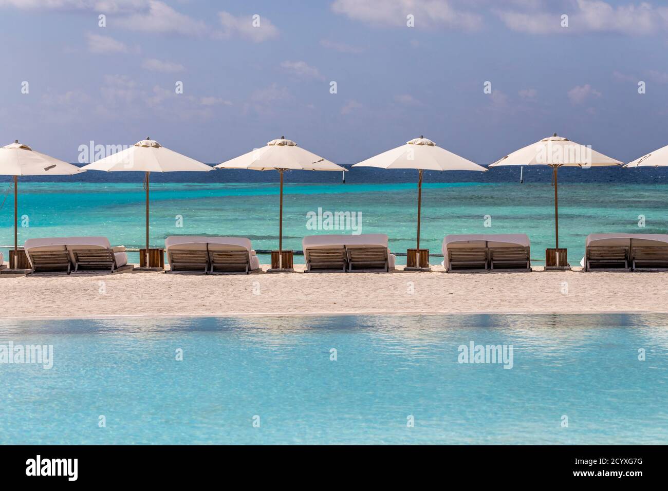 Como Maalifushi; Sun Loungers and Parasols; Maldives Stock Photo