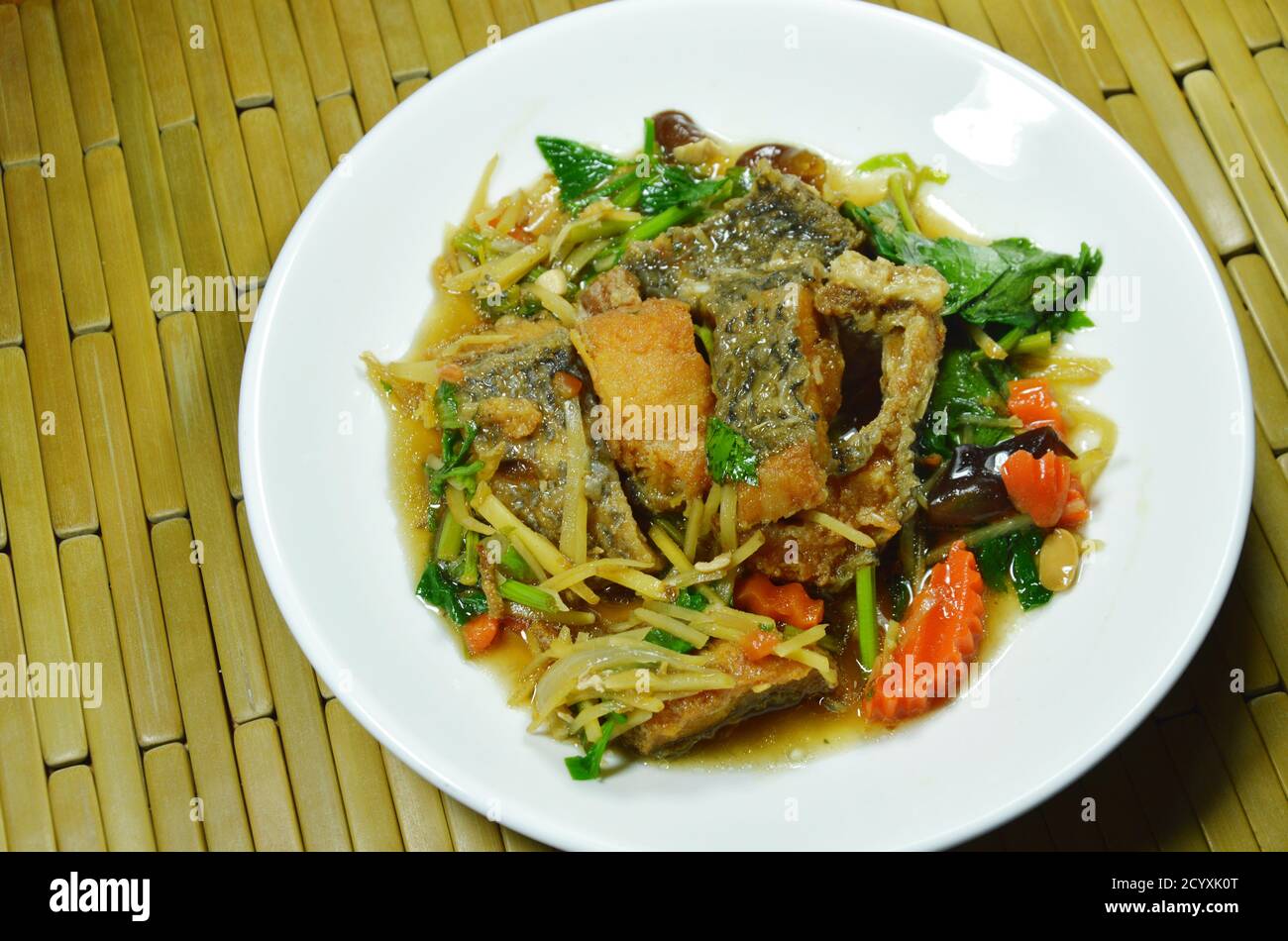 crispy fried fish with slice ginger and soy sauce on plate Stock Photo ...