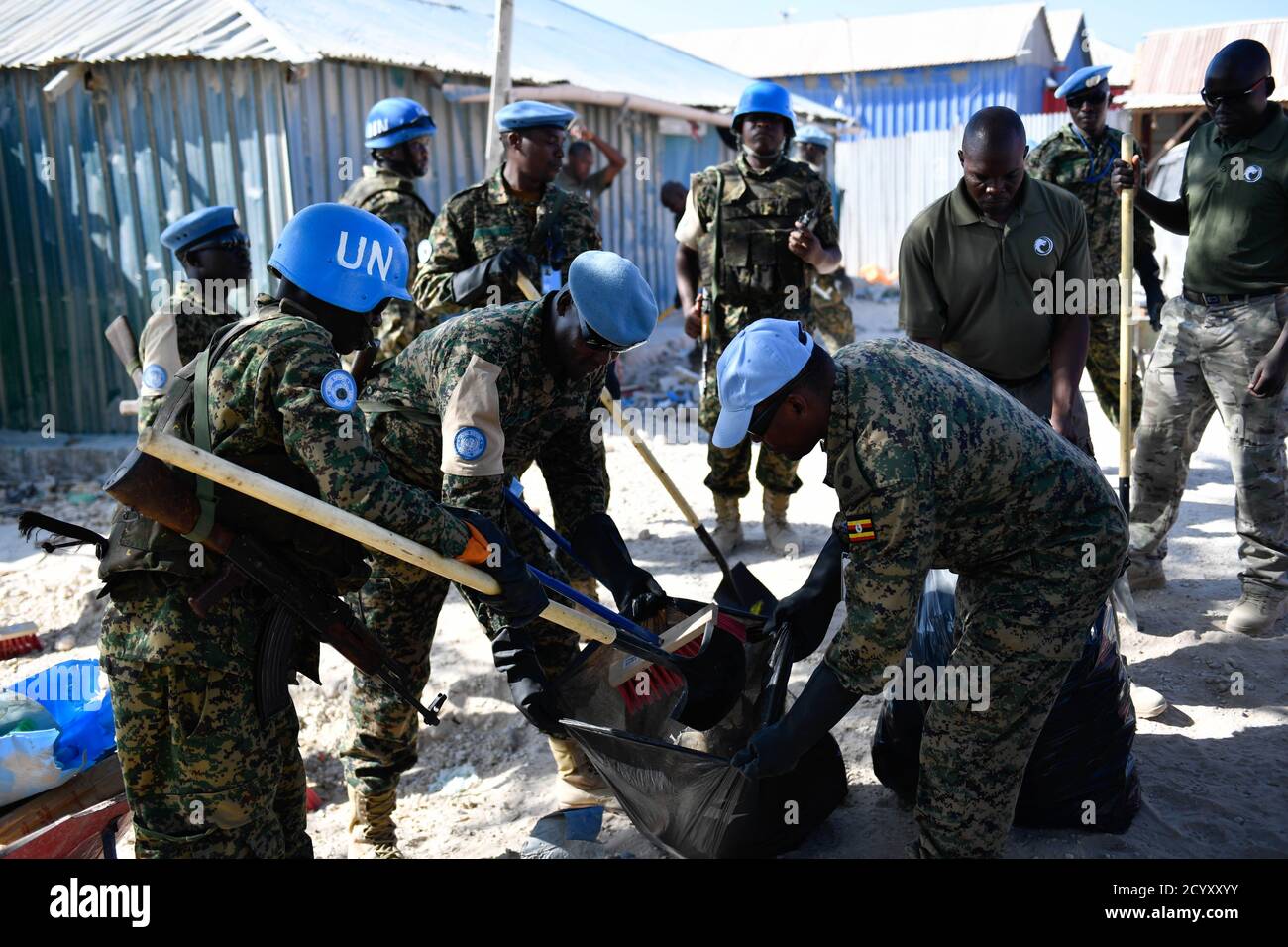 Ugandan soldiers serving under the United Nations Guard Unit in Somalia carry out a community cleanup exercise in Mogadishu, Somalia on February 06, 2019. This was part of activities organised by the Ugandan military to mark 'Tarehe Sita' day in commemoration of the 38th anniversary of the founding of the Uganda People's Defence Forces (UPDF) on 06 February 1981. Stock Photo