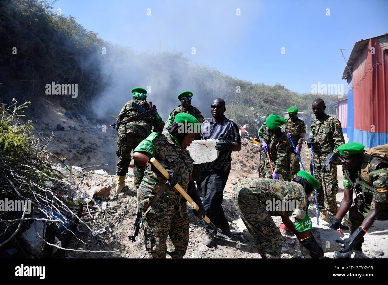 Ugandan soldiers serving under the African Union Mission in Somalia (AMISOM) carry out a community cleanup exercise in Mogadishu, Somalia on February 06, 2019. This was part of activities organised by the Ugandan military to mark 'Tarehe Sita' day in commemoration of the 38th anniversary of the founding of the Uganda People's Defence Forces (UPDF) on 06 February 1981. Stock Photo