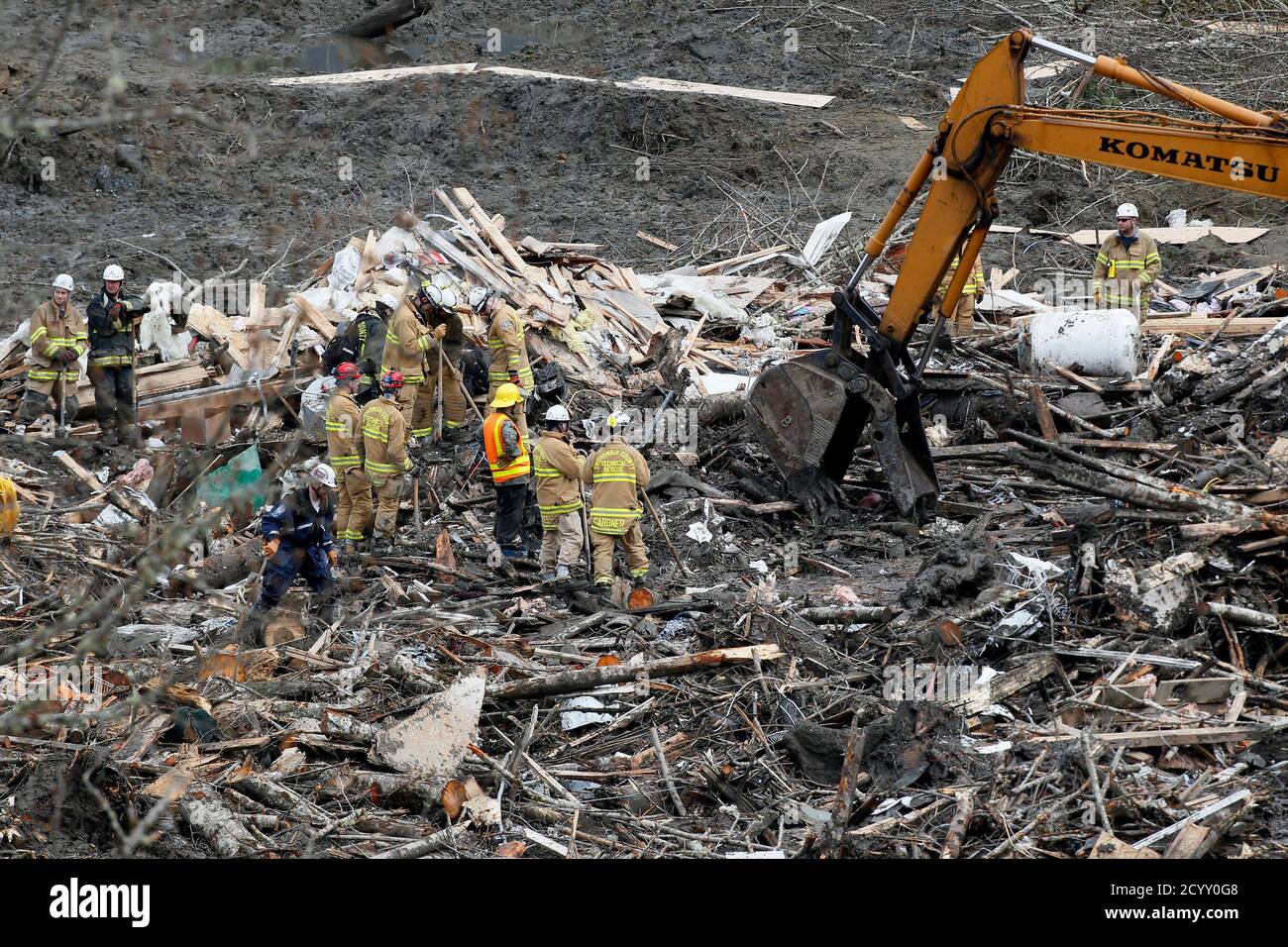 Rescue workers look for victims in the mudslide near Oso, Washington March 26, 2014. The death toll from a massive landslide in Washington state stood at 24 on Wednesday, but the mud-stricken community braced for a higher body count as search teams combed through debris looking for scores of people still missing four days after the disaster. REUTERS/Rick Wilking(UNITED STATES - Tags: DISASTER ENVIRONMENT) Stock Photo
