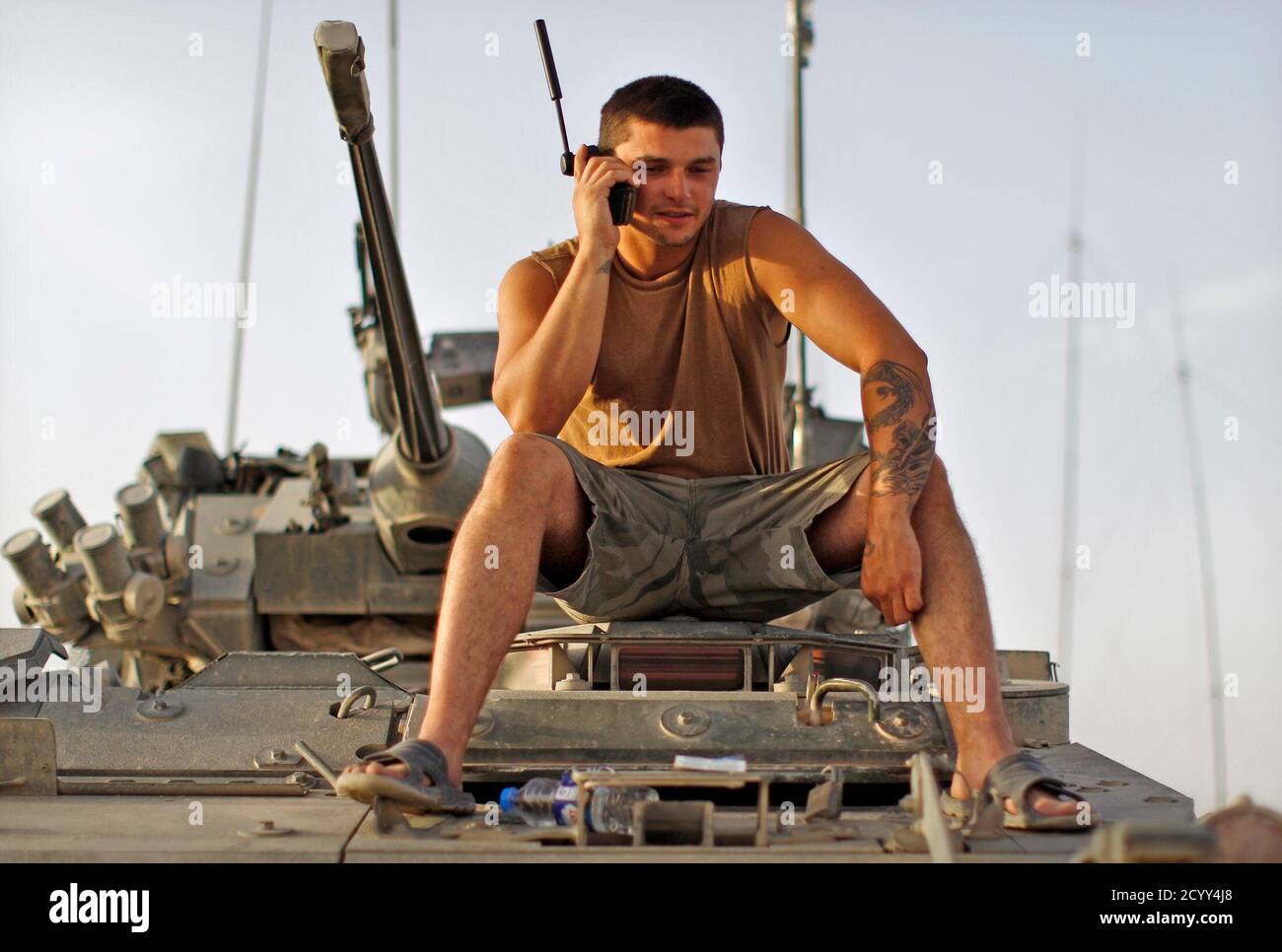 Corporal Matt Hatt of the Canadian Army's 1st Battalion, The Royal Canadian  Regiment Battle Group, talks on his satellite phone at a combat outpost  near the village of Salavat, in the Panjway