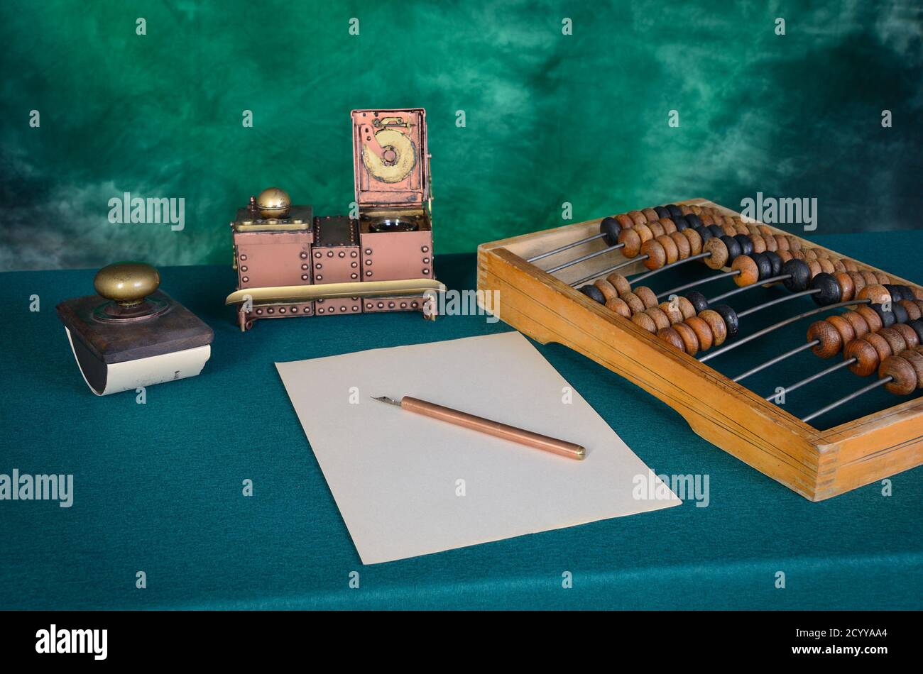 Old writing utensils on green cloth Stock Photo Alamy