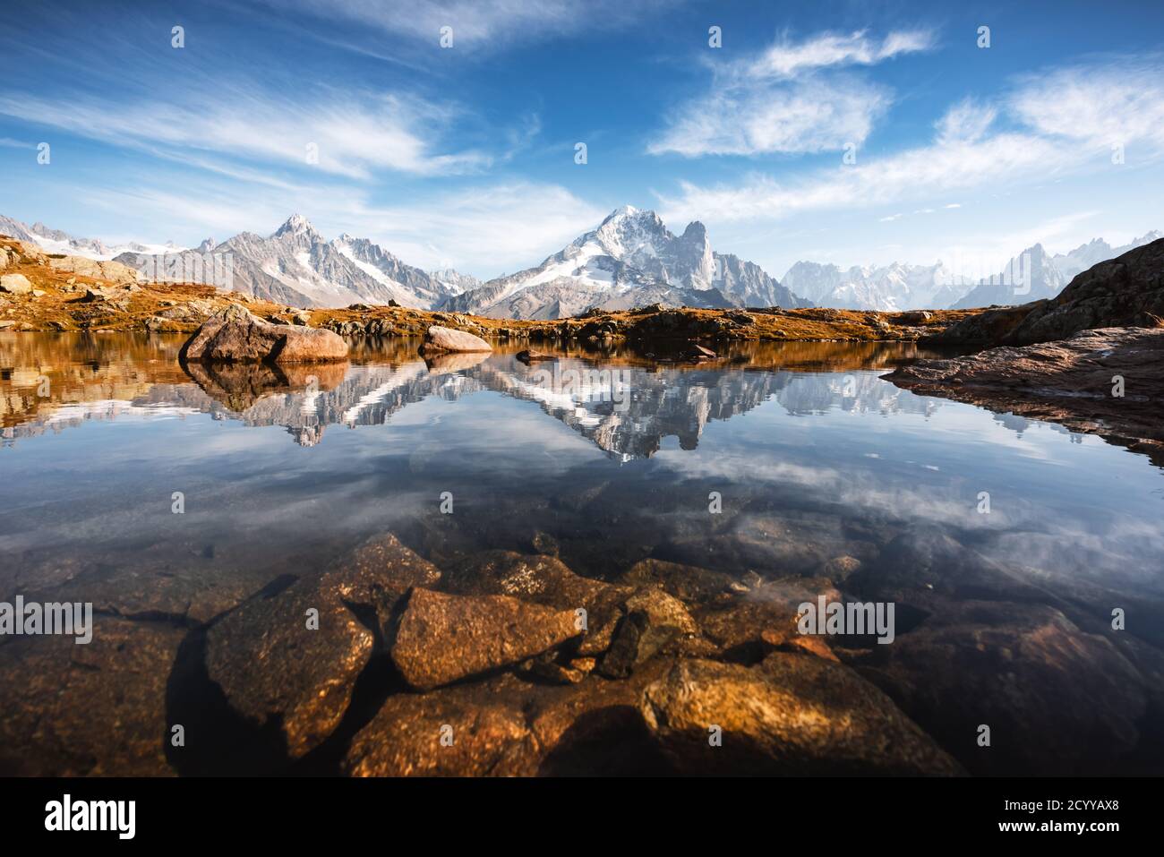 Incredible view of clear water and sky reflection on Lac Blanc lake in France Alps. Monte Bianco mountains range on background. Landscape photography, Chamonix. Stock Photo