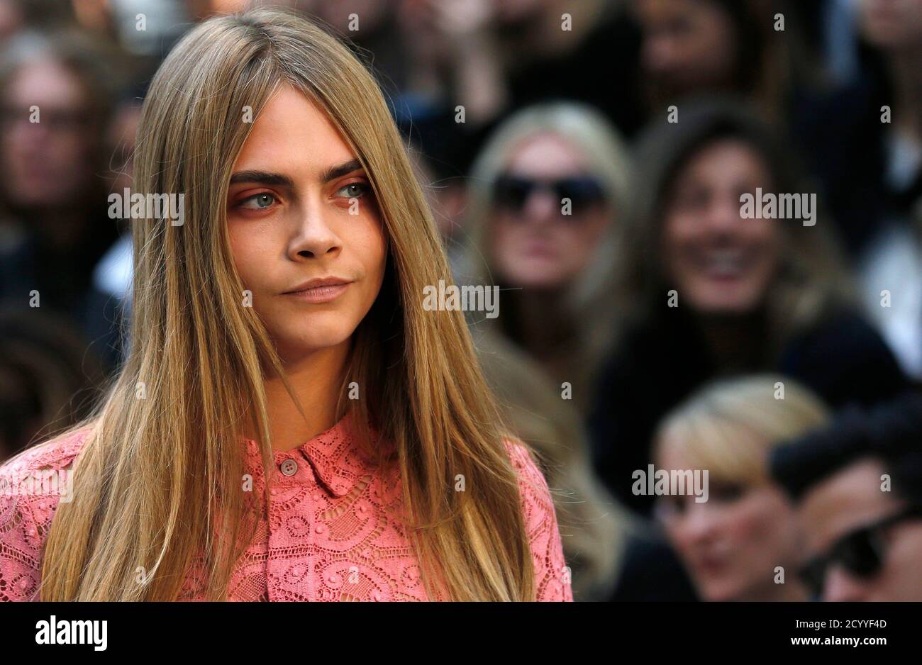 Model Cara Delevingne presents a creation from the Burberry Prorsum  Spring/Summer 2014 collection during London Fashion Week September 16,  2013. REUTERS/Suzanne Plunkett (BRITAIN - Tags: FASHION Stock Photo - Alamy