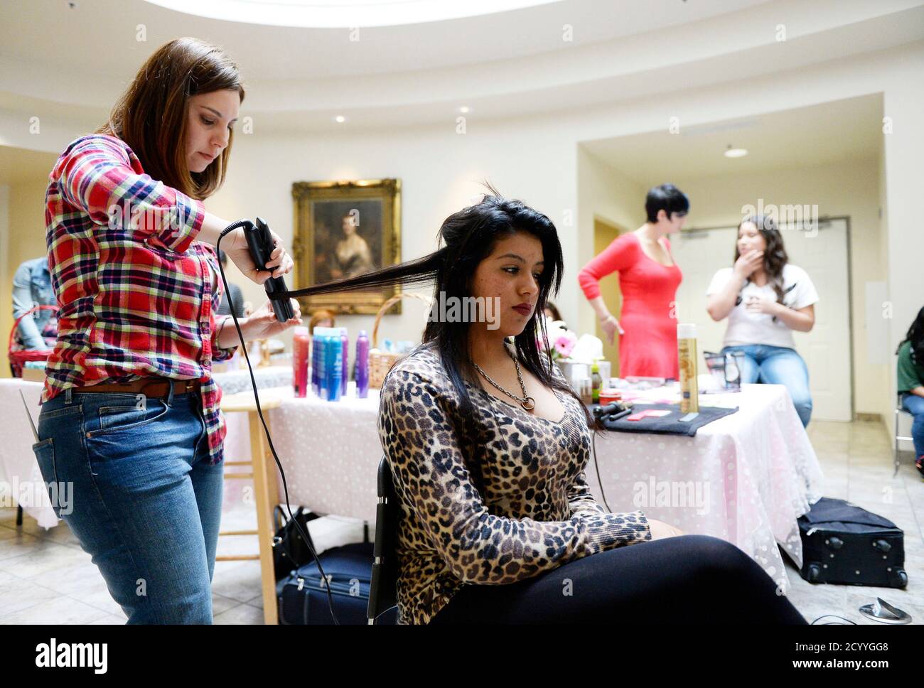 Rebecca Gutierrez, 17, from Linda Marquez High School, gets her hair done  after picking a prom dress at Operation School Bell's Prom Day event at the  Assistance League of Southern California headquarters