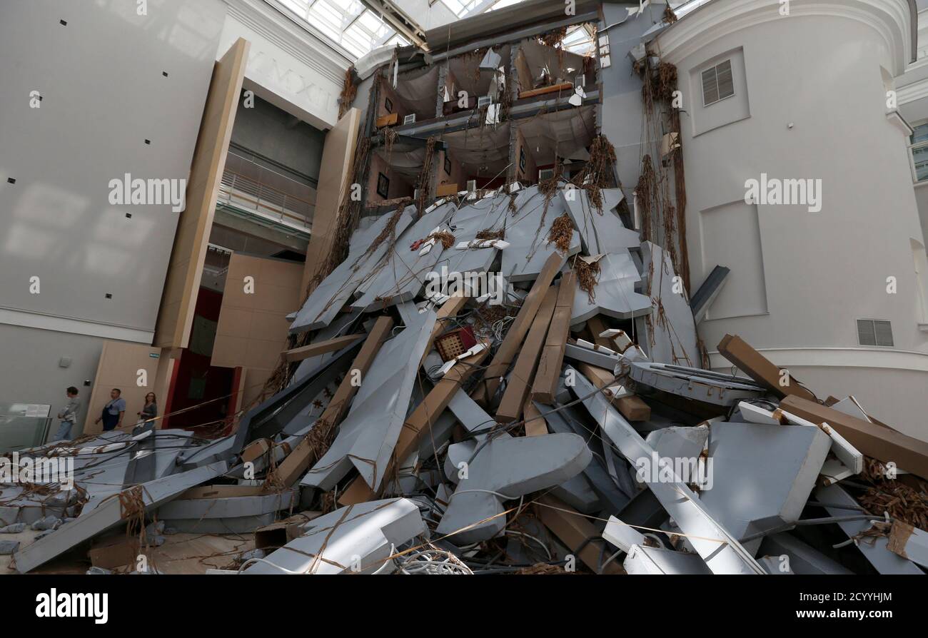 Visitors walk past an installation called 'Abschlag' by Swiss artist Thomas Hirschhorn at the State Hermitage Museum during the Manifesta 10 European Biennial of Contemporary Art in St. Petersburg July 11, 2014. This year will mark the 20th anniversary of Manifesta, the European Biennial of Contemporary Art, which was initiated in response to the new social, cultural and political reality that emerged in the aftermath of the Cold War, according to its organisers. REUTERS/Alexander Demianchuk (RUSSIA - Tags: SOCIETY) Stock Photo