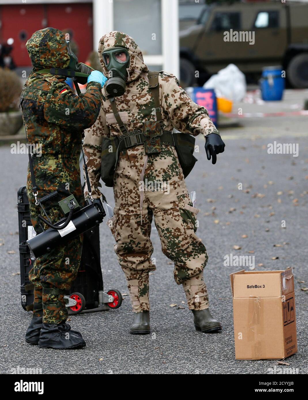 German army soldiers arrive to inspect the content of a parcel during the  ABC FTX14 joined drill of the Swiss and German army Bundeswehr in Thonex  near Geneva November 14, 2104. Some