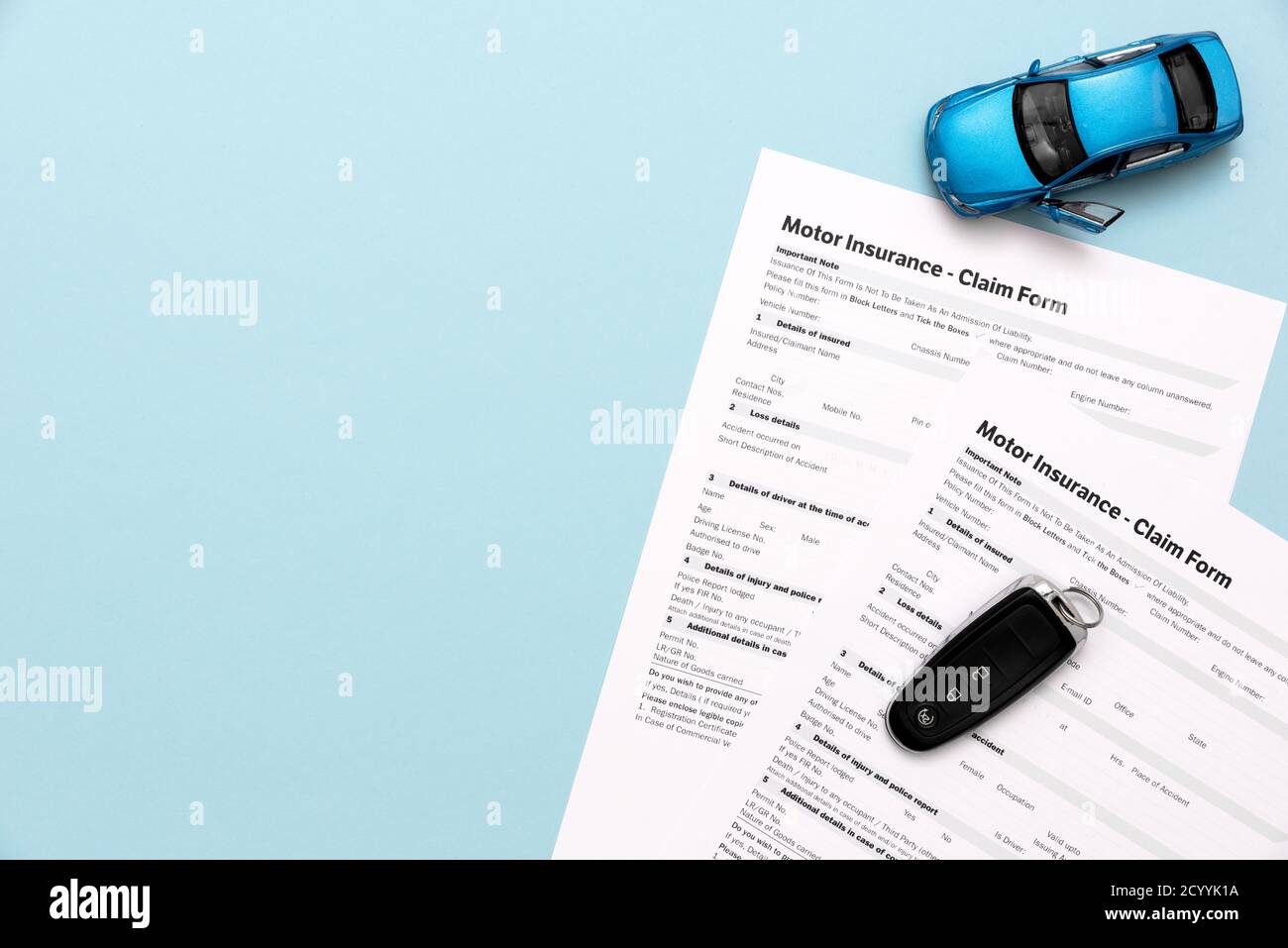 Car insurance, insurance contract and car keys on a blue background Stock Photo