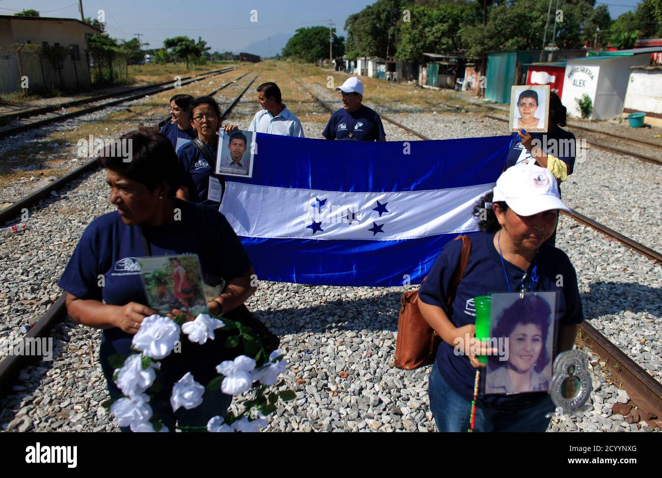 Activists From A 13 Member Caravan Hold A Honduras Flag Near Pictures Of Missing Migrants In Ixtepec November 2 10 The Members Of The Caravan Are On A Journey To Search For More