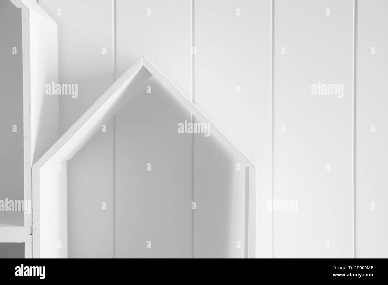 Abstract architectural background with white wooden shelves near a wall, modern interior backdrop Stock Photo