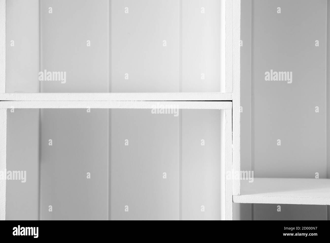 Abstract architectural background with empty white wooden shelves, modern interior backdrop Stock Photo