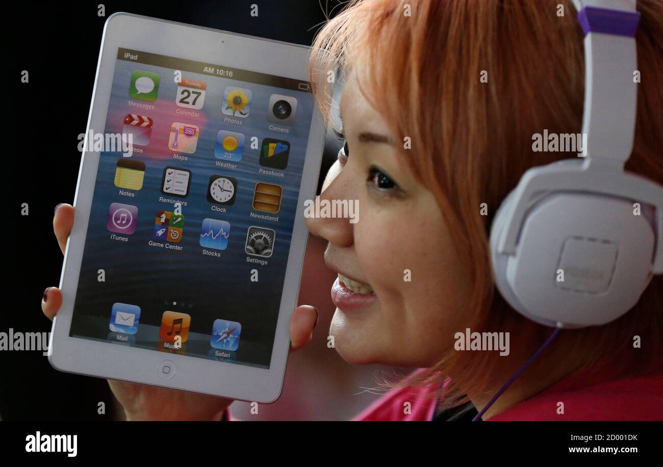 A woman holds a mock model of Apple's new iPad mini as she waits for the  release of the tablet in front of the Apple Store Ginza in Tokyo November  1, 2012.