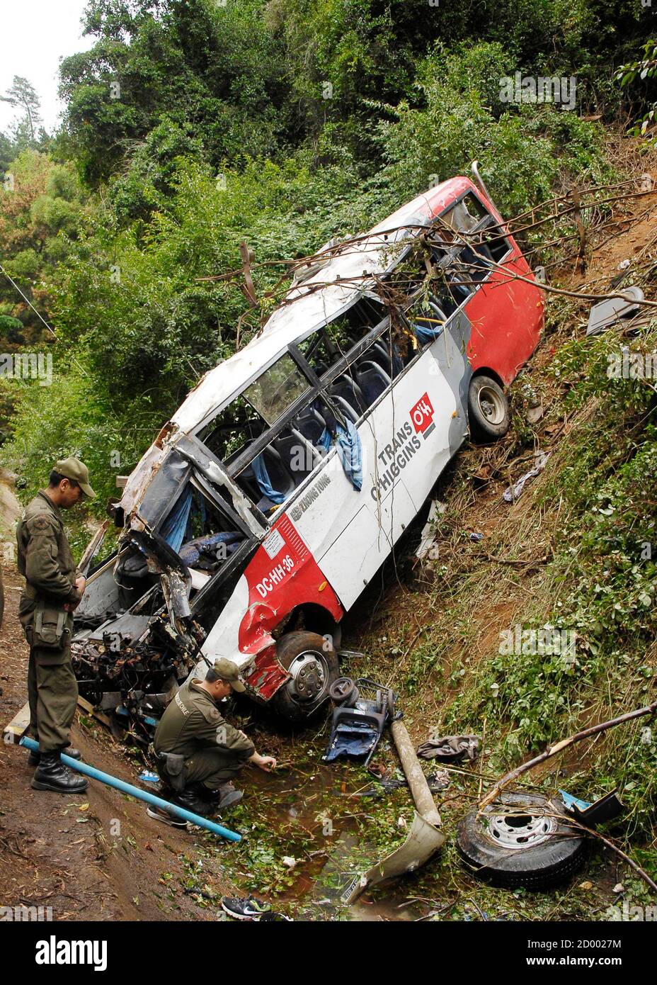 Policemen inspect a passenger bus after an accident along Route CH-150,  known as Cuesta Caracol, in Tome city near Concepcion, some 526 km (327  miles) south of Santiago, February 9, 2013. Sixteen