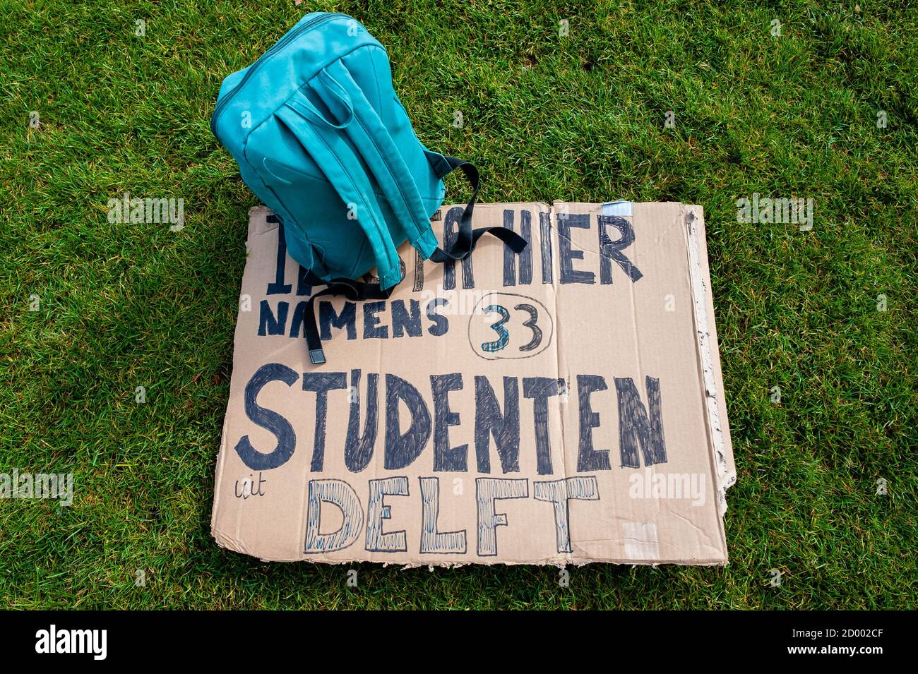 A backpack lies on the ground next to a placard during the demonstration.Due to the measures against Covid-19, only 10 to 30 percent of education takes place in Schools. Some students don’t get to visit their campus at all, and teachers are struggling to digitalize their courses. Because of that, the Amsterdam student unions ASVA and SRVU, the National Student Union together with the #ikwilaansschool action group organized a protest to demand financial resources to provide safe physical education. Students and teachers gathered at the Museumplein holding placards in representation of students Stock Photo
