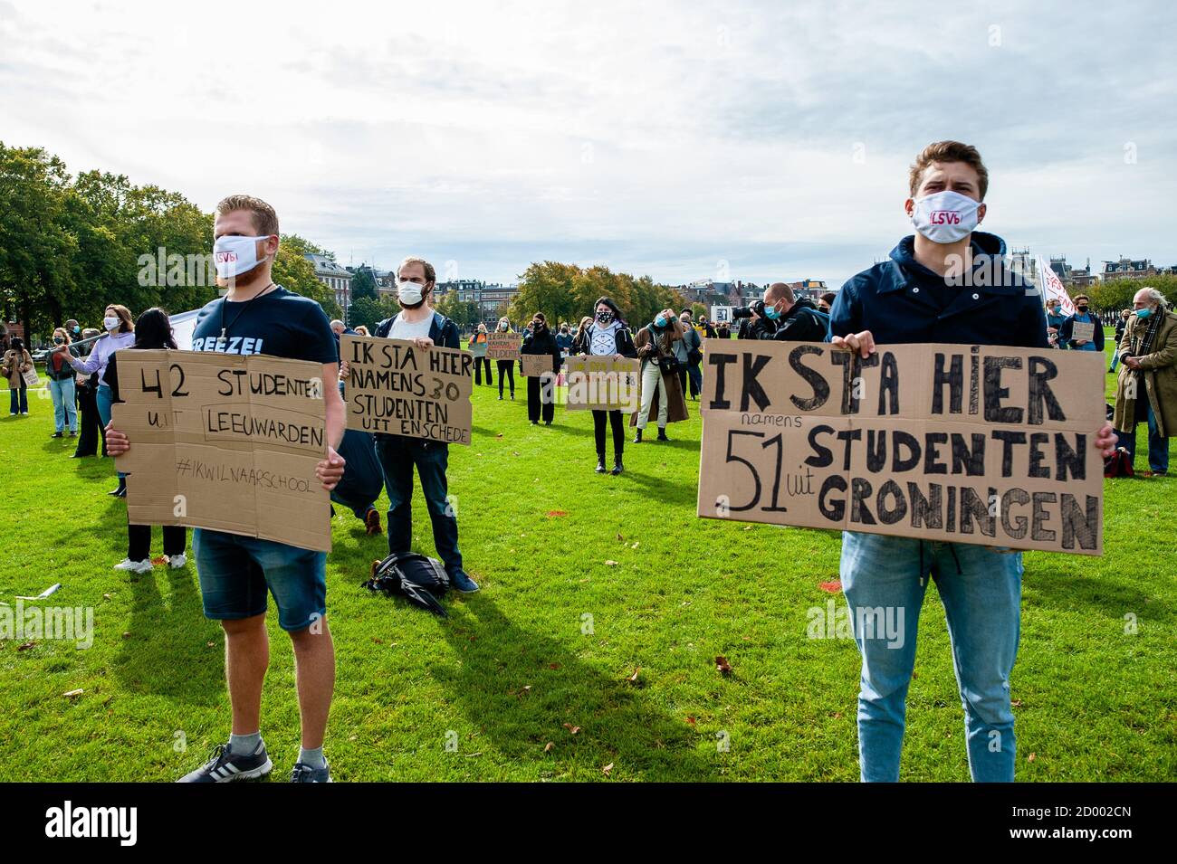 Students wearing face masks hold placards during the demonstration. Due to the measures against Covid-19, only 10 to 30 percent of education takes place in Schools. Some students don’t get to visit their campus at all, and teachers are struggling to digitalize their courses. Because of that, the Amsterdam student unions ASVA and SRVU, the National Student Union together with the #ikwilaansschool action group organized a protest to demand financial resources to provide safe physical education. Students and teachers gathered at the Museumplein holding placards in representation of students from Stock Photo