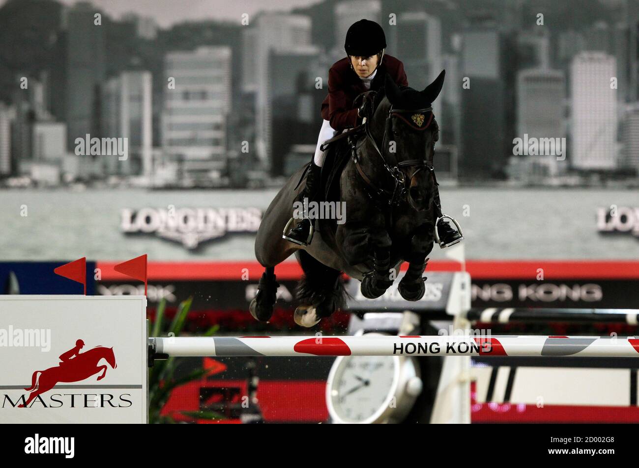 Edwina Tops-Alexander of Australia riding Guccio clears a hurdle to finish second runner-up during Gucci Gold Cup 1.50-meter jumping competition as part of the Longines Hong Kong Masters March 1, 2013.  REUTERS/Bobby Yip (CHINA - Tags: SPORT EQUESTRIANISM) Stock Photo