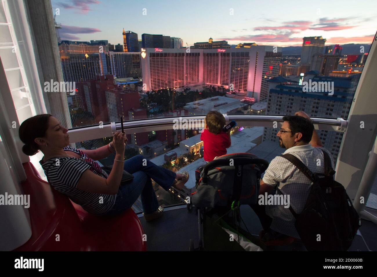 Carolina Higuera (L) of Mexico takes a photo of her son and husband while riding the 550 foot-tall (167.6 m) High Roller observation wheel, the tallest in the world, in Las Vegas, Nevada April 9, 2014. The wheel is the centerpiece of the $550 million Linq project, a retail, dining and entertainment district by Caesars Entertainment Corp. REUTERS/Las Vegas Sun/Steve Marcus (UNITED STATES - Tags: TRAVEL BUSINESS SOCIETY) Stock Photo