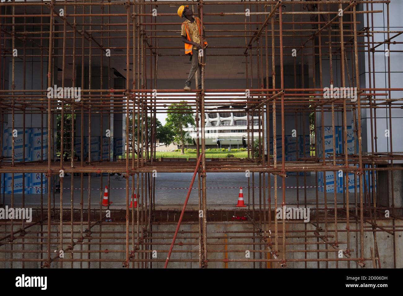 A man works at the National Arts Theatre stop of the light rail system under construction in Lagos, Nigeria, May 30, 2014. Started in 2009 to ease traffic, Lagos state government is building a rail system with the China Civil Engineering Construction Corporation. The first test runs should start in 2015, according to an official at the National Arts Theatre work site. REUTERS/Joe Penney (NIGERIA - Tags: BUSINESS CONSTRUCTION EMPLOYMENT TRANSPORT POLITICS SOCIETY) Stock Photo