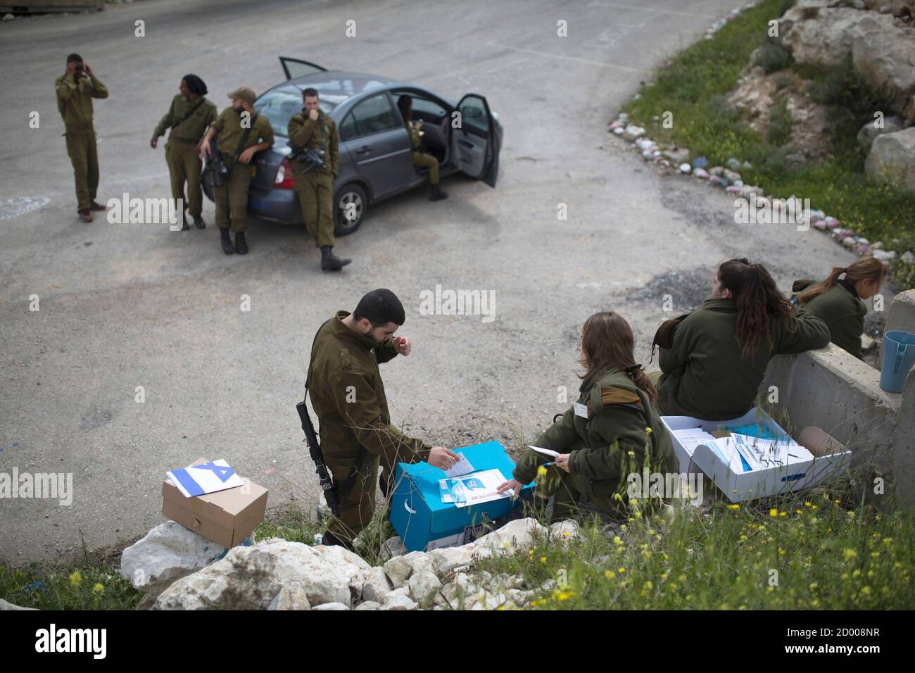 An Israeli soldier casts his ballot for the parliamentary election in a  mobile ballot box at an army base on Mount Gerizim, near the West Bank City  of Nablus March 17, 2015.