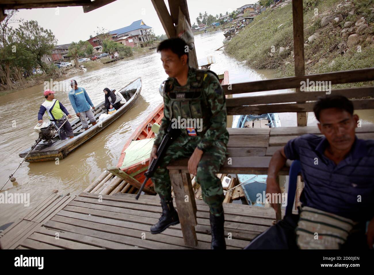 A Soldier Holds His Weapon On The Thai Side Of The River As People Cross Into Malaysia In Sungai Kolok In Southern Narathiwat Province March 8 2013 Last Week In A Deal