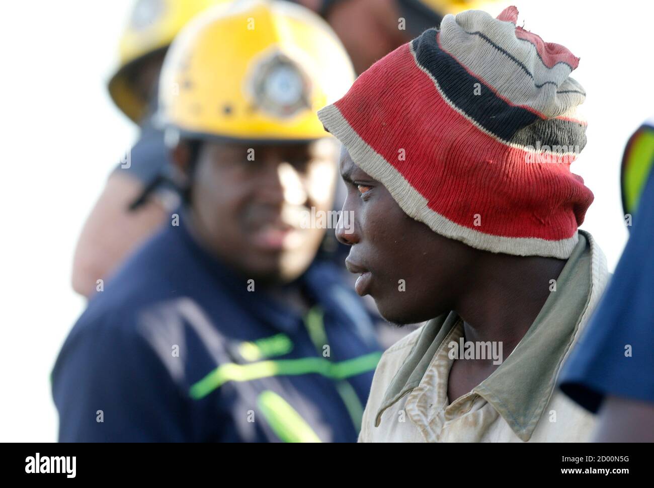 A suspected illegal miner is led away after being rescued from an abandoned gold shaft in Benoni, east of Johannesburg, February 16, 2014. South African rescuers started bringing to the surface at least 30 illegal miners on Sunday who had been trapped by debris in the abandoned gold shaft near Johannesburg, emergency services ER24 spokesman Werner Vermaak said. There were no immediate reports of deaths or injuries. Vermaak later told Reuters that some of the miners still underground were refusing to come up, saying they did not want to be arrested. REUTERS/Mike Hutchings (SOUTH AFRICA - Tags:  Stock Photo