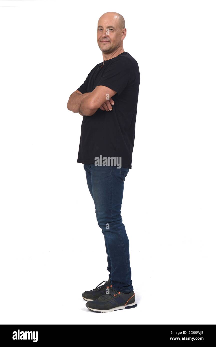 full portrait of a man side view and looking at camera, arms crossed on ...