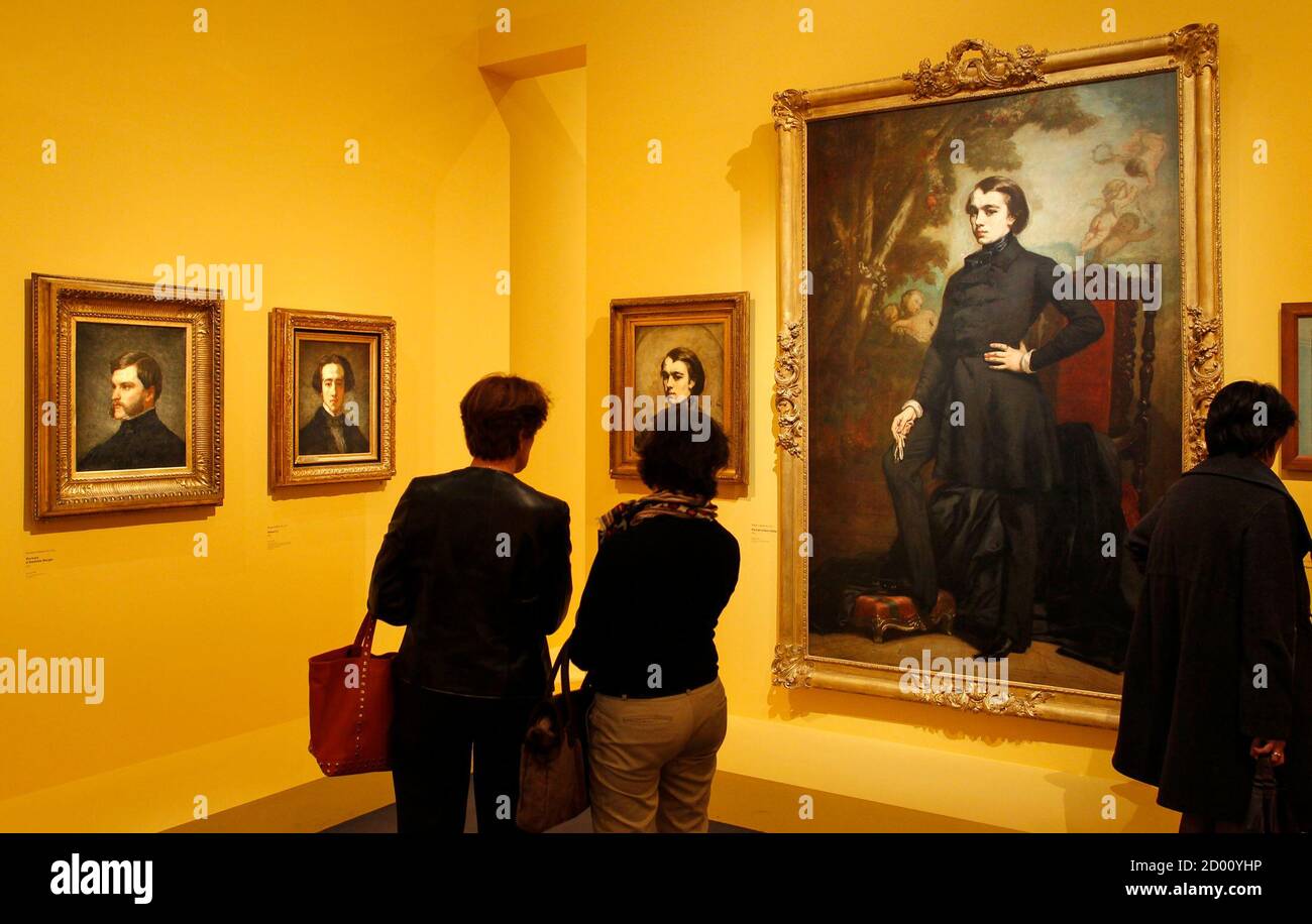 Visitors look at paintings by French painter Edouard (18321883