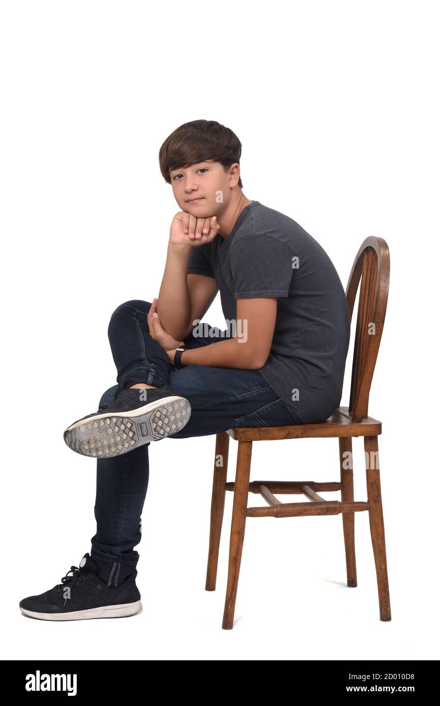 Teenage Boy Sitting On A Chair With White Background Teenage Boy Sitting On A Chair With White Background